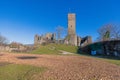A castle tower and ruins on a hill under a bright blue sky Royalty Free Stock Photo