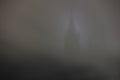 Castle tower silhouette in fog