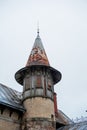 Castle tower with weathered spire shows historic architecture Royalty Free Stock Photo