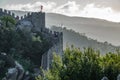 Castle wall across the hill with tourists