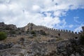 Castle walls of Alanya with tree branches Royalty Free Stock Photo