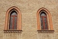 Castle window in a medieval style. Double arched window on a facade of medieval wall. Biforium - ancient window with Royalty Free Stock Photo