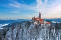 Castle in winter. Romantic fairytale castle in picturesque highland landscape, covered in snow.