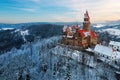 Castle in winter. Romantic fairytale castle in picturesque highland landscape, covered in snow.