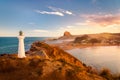 Castlepoint Lighthouse and the village of Castlepoint with Castle Rock in the distance.