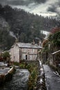 Castleton Beautiful old rural idyllic village cottage with smoke from chimney Peak District river peacefully flowing during winter Royalty Free Stock Photo