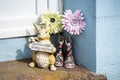 Castletown,Isle of Man, June 16, 2019.Bunny Rabbit Home or Garden Animal Figurine, Statue, flowers and a pair of wellingtons.