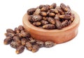 Castor beans in a wooden bowl