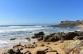 Wild beach with rocks, big waves and prehistoric settlement ruins. Sunny day, Barona, Galicia, Spain.