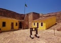 Castro Marim castle, with medieval stocks and yellow buildings at background Royalty Free Stock Photo