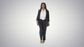 Casual African American Businesswoman walking on gradient backgr