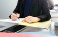 Casual Asian businessman in black suit sign paperwork