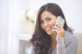 casual asian woman making a phone call at home using smart phone Royalty Free Stock Photo