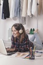 Casual blogger woman working with laptop in her fashion office. Royalty Free Stock Photo