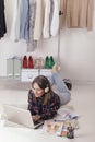 Casual blogger woman working with laptop in her fashion office. Royalty Free Stock Photo