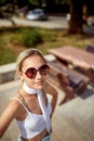 Casual blonde with sunglasses chilling outside in nature at summer holiday. Selfie like shot. Travel, holiday, leisure, lifestyle