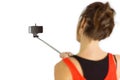 Casual brunette using selfie stick Royalty Free Stock Photo