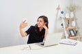 Casual Business Asian Woman taking a selfie with smartphone in f Royalty Free Stock Photo