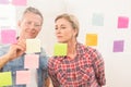 Casual business colleagues writing on sticky notes Royalty Free Stock Photo