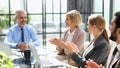 Casual business people around conference table in office Royalty Free Stock Photo