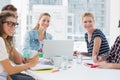 Casual business people around conference table in office Royalty Free Stock Photo