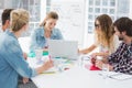 Casual business people around conference table in office Royalty Free Stock Photo