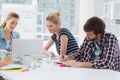 Casual business people around conference table in office Royalty Free Stock Photo