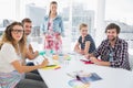 Casual business people around conference table in office Royalty Free Stock Photo