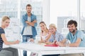 Casual business people around conference table in office Royalty Free Stock Photo