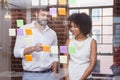 Casual business team looking at sticky notes Royalty Free Stock Photo