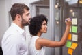 Casual business team looking at sticky notes Royalty Free Stock Photo