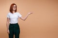 Casual business woman in glasses showing hand isolated at studio background Royalty Free Stock Photo