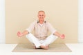 Casual business yoga smiling senior man meditate Royalty Free Stock Photo