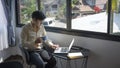 Businessman drinking coffee and surfing internet on laptop computer at office.