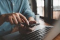 Casual Businessman hand holding and using smartphone for sms messages, man typing touchscreen cell phone in the office. business, Royalty Free Stock Photo