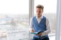 Casual businessman with pen in writing on paper notebook in office in shirt Royalty Free Stock Photo