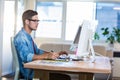 Casual businessman using digitizer at his desk