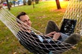 Casual Businessman Using Laptop Lying In Hammock At Park Royalty Free Stock Photo