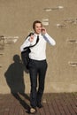 Casual businessman walking and talking on phone outdoors Royalty Free Stock Photo