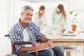 Casual businessman in wheelchair with notepad Royalty Free Stock Photo