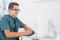 Casual businessman working at desk with computer and digitizer Royalty Free Stock Photo