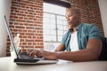 Casual businessman working on laptop at desk Royalty Free Stock Photo