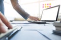 Casual businessman working in office, sitting at desk, typing on Royalty Free Stock Photo