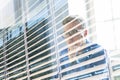 Casual businessman working in office, sitting at desk, typing on keyboard, looking at computer screen. Royalty Free Stock Photo