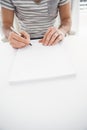 Casual businessman writing at his desk Royalty Free Stock Photo