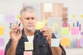 Casual businessman writing on post its Royalty Free Stock Photo