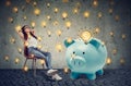 Casual businesswoman with big piggy bank relaxing sitting on chair Royalty Free Stock Photo