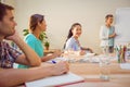 Casual businesswoman giving presentation to her colleagues Royalty Free Stock Photo