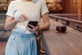 Casual Businesswoman holding and using smartphone for sms messages, young woman typing touchscreen mobile phone in coffee cafe or Royalty Free Stock Photo