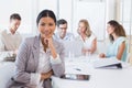 Casual businesswoman smiling at camera during meeting Royalty Free Stock Photo